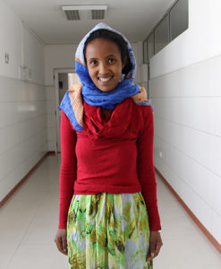 Photo of Child in Ethiopia in Red Top & Long Green Floral Skirt